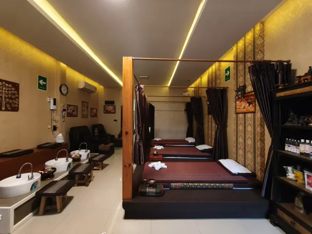 Long front room with a foot-wash station and curtained mats at Ai Oon Massage Lanna, Chiang Mai