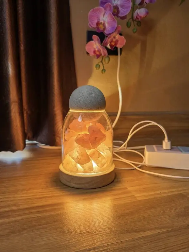 Glowing salt lamp on a wooden floor in a massage room at Ai Oon Massage Lanna