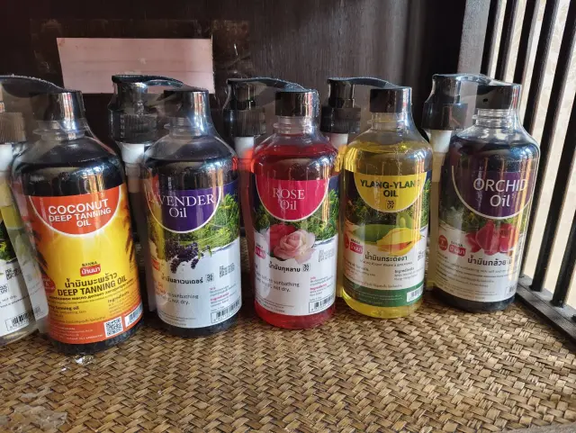Bottles of coconut, lavender, rose and ylang-ylang massage oil used for Thai oil massage in Chiang Mai