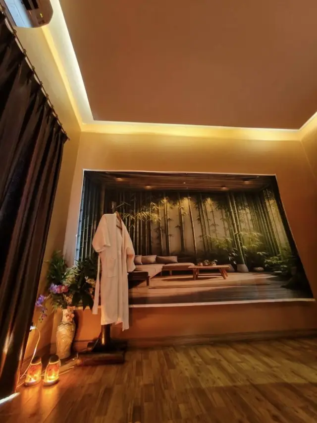 Massage room with a bamboo forest wall mural and a robe hanging near the bed, Chiang Mai