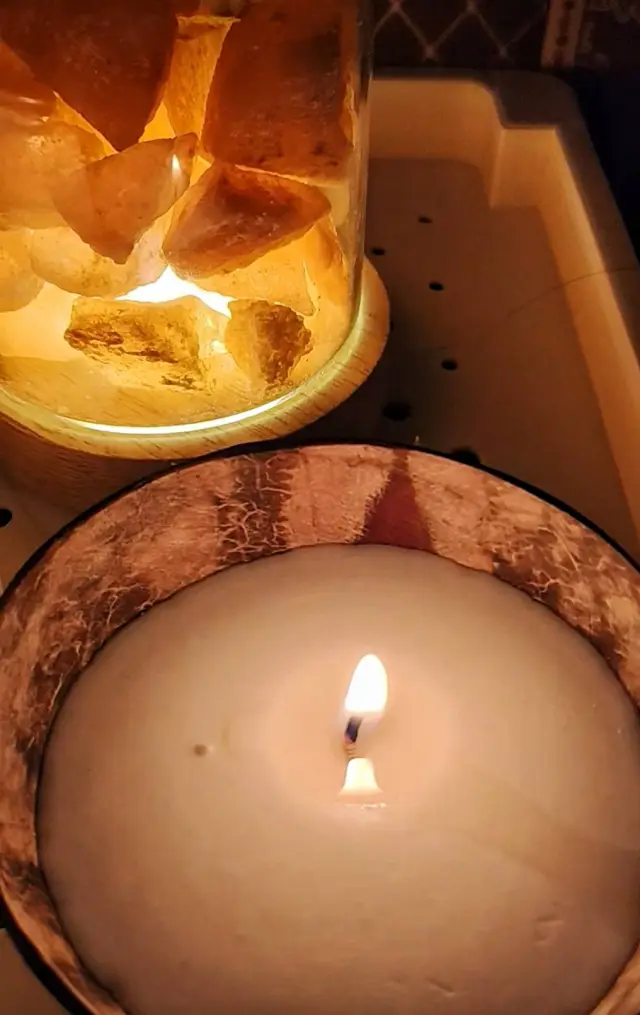 Close-up of a salt lamp jar and a lit candle in a bowl at Ai Oon Massage Lanna